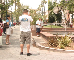 Vistors pose for pictures in front of Promenade dinosaur fountail