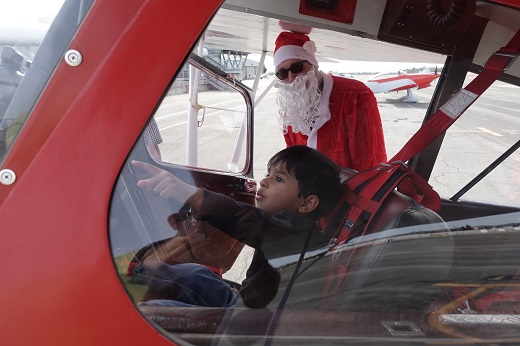 Boy checks out Santa's plane at Santa Monica Airport